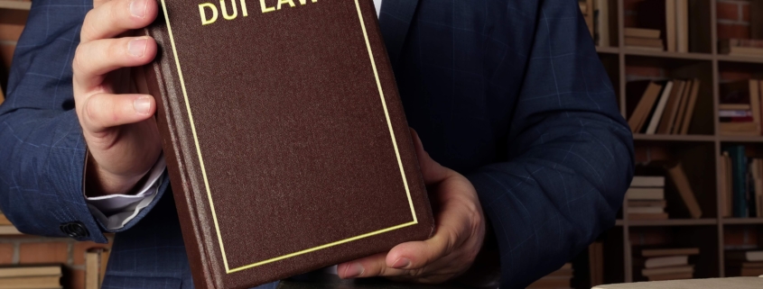DUI attorney holding up DUI law book