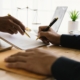 person signing settlement documents with lawyer