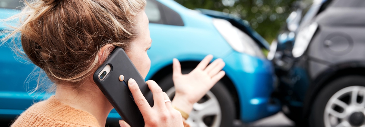 a frustrated woman on the phone after a car accident