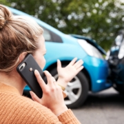a frustrated woman on the phone after a car accident