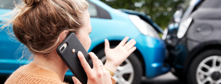 a frustrated woman on the phone after a car accident