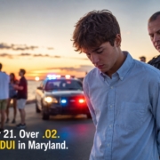 Maryland police officer detains a distressed young man near a patrol car with flashing lights at sunset as teens gather in the background after a summer celebration, illustrating the consequences of underage DUI.